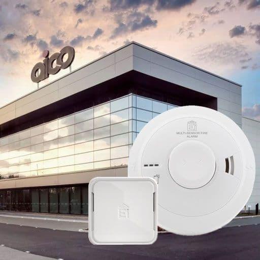 Modern office building with large glass windows, multi-sensor fire alarm devices in front